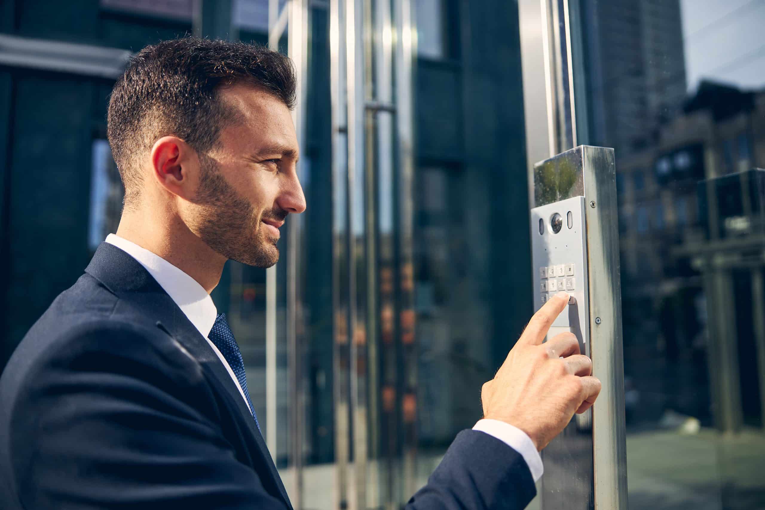 Profissional utilizando sistema de controle de acesso moderno em portaria, representando serviços de portaria integrados com tecnologia e vigilância.